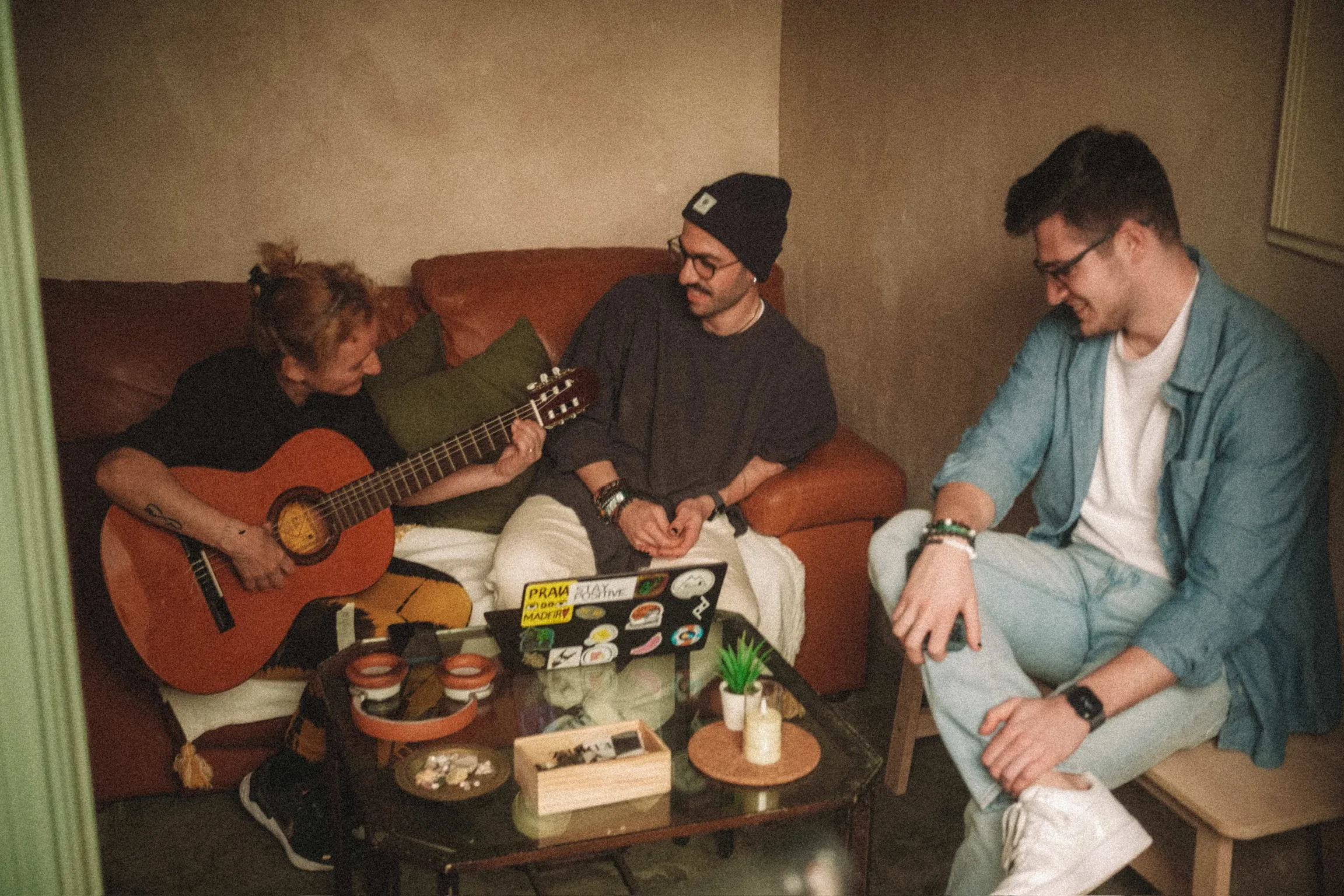 Friends sharing wine, snacks, and stories in a cozy coliving space